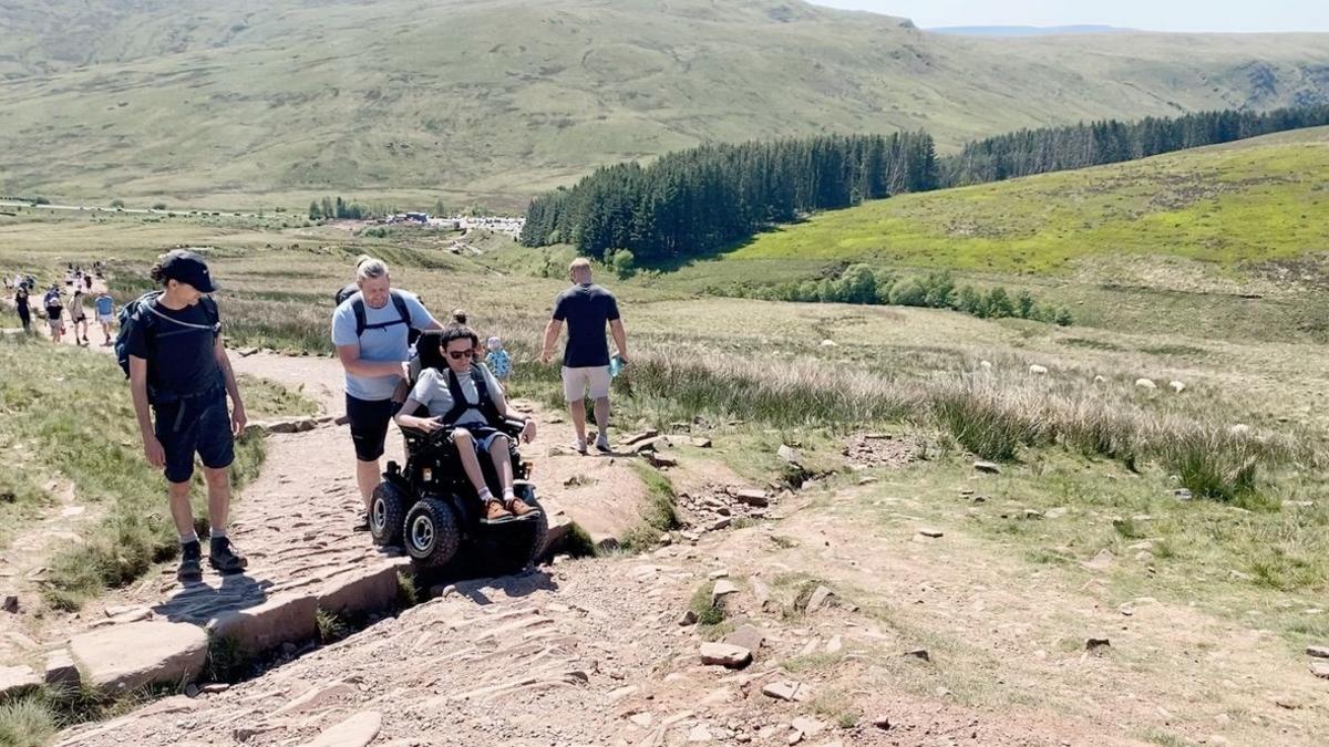 Josh Wintersgill in his motorised, all terrain wheelchair making his way up a path on the Welsh mountain Pen Y Fan