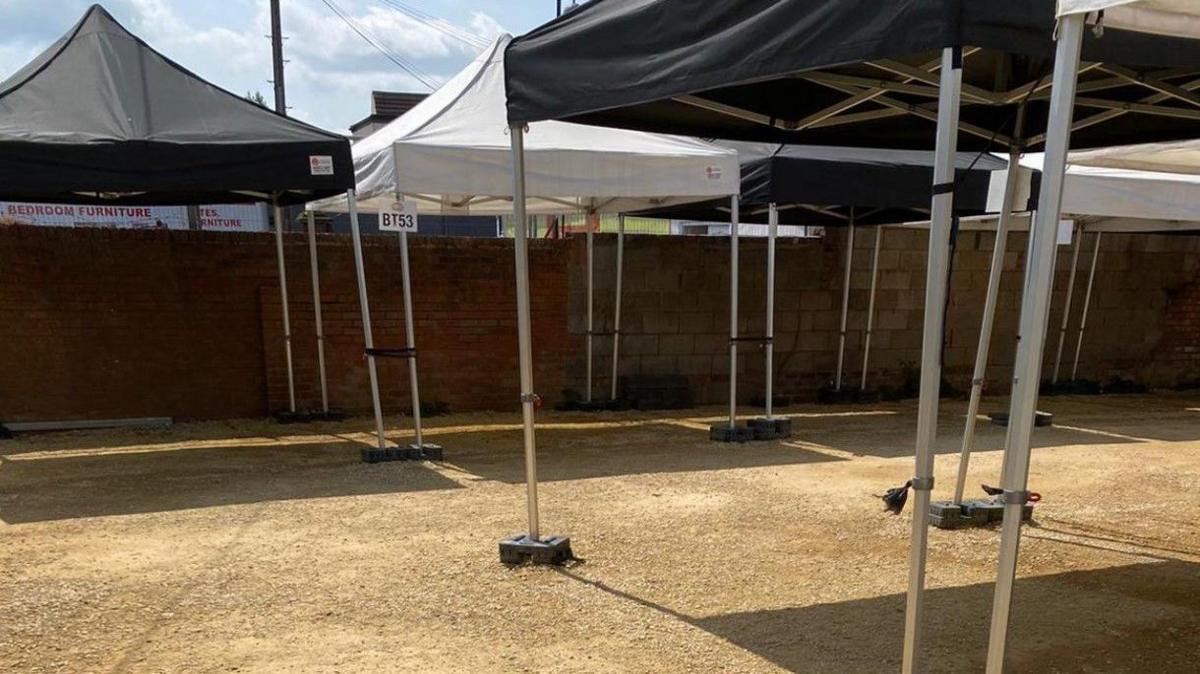 A number of canopies, black and white, with nothing below them.