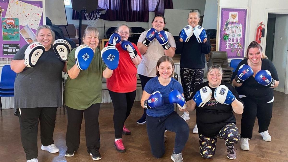 Women wearing boxing gloves 