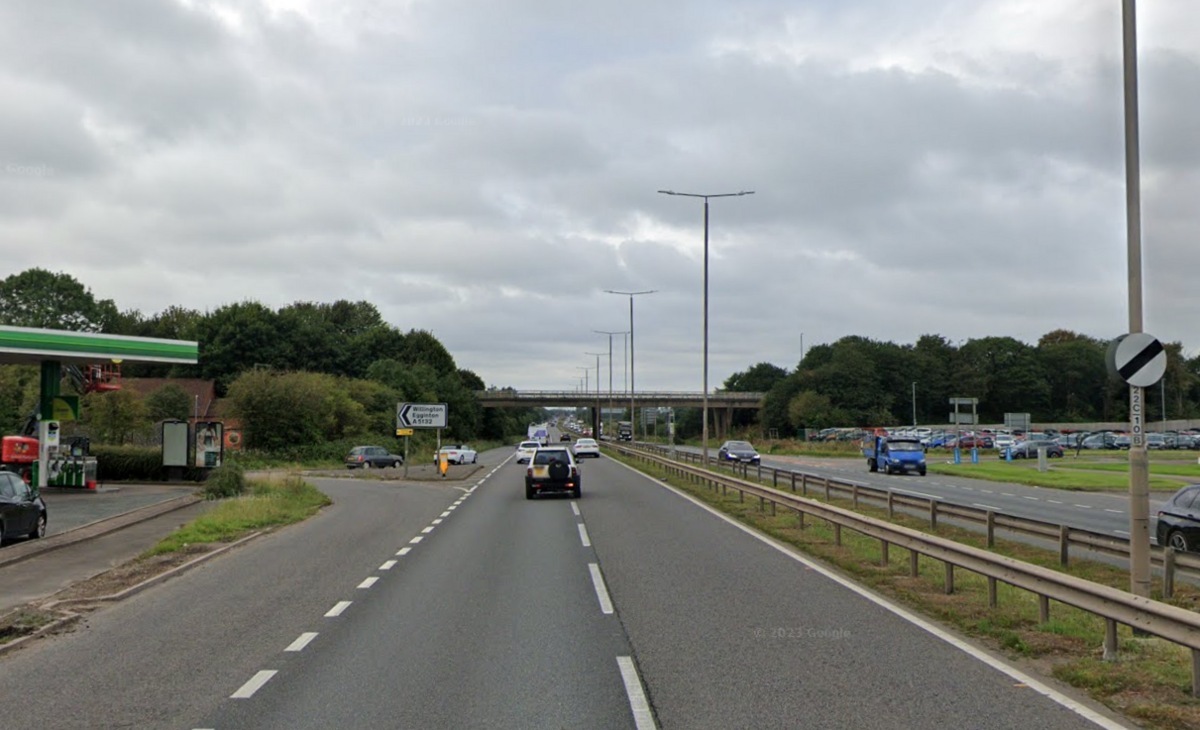 The Egginton junction of the A38 dual carriageway with petrol stations on both sides of the road, near the slip road exits from the bridge up ahead