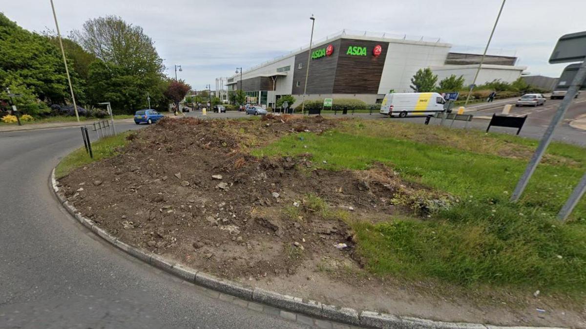 The Mill Dam roundabout after the stones were removed. A large section of the roundabout has been removed leaving dirt and rumble. The missing section takes up about a third of the roundabout's centre.