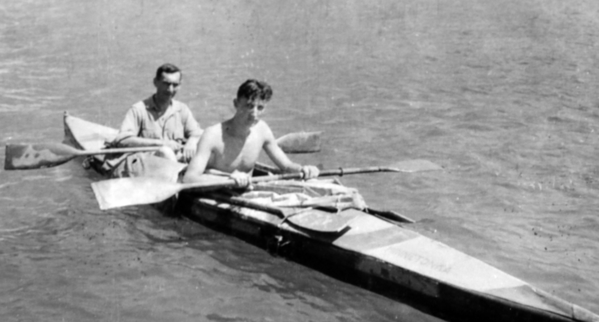 A b&w photo of two original COPP kayakers in a boat