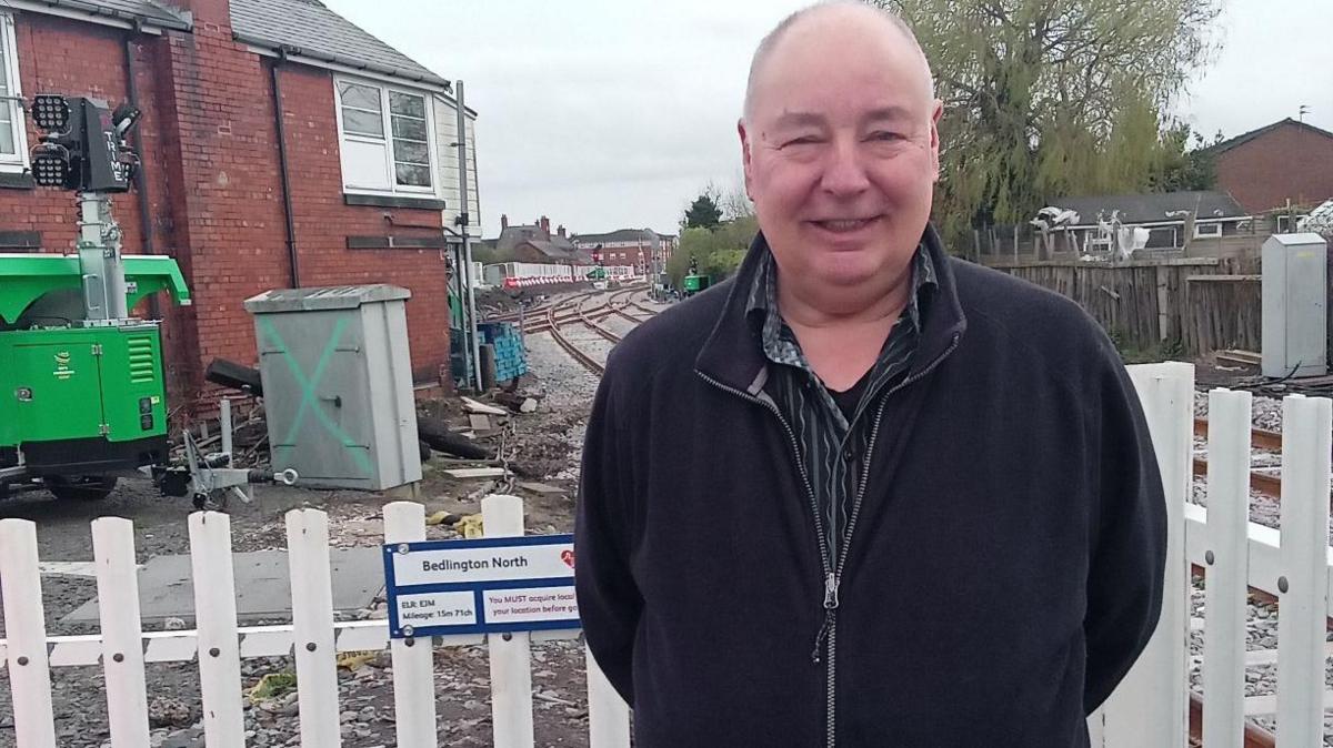 Dennis standing in front of Bedlington North station