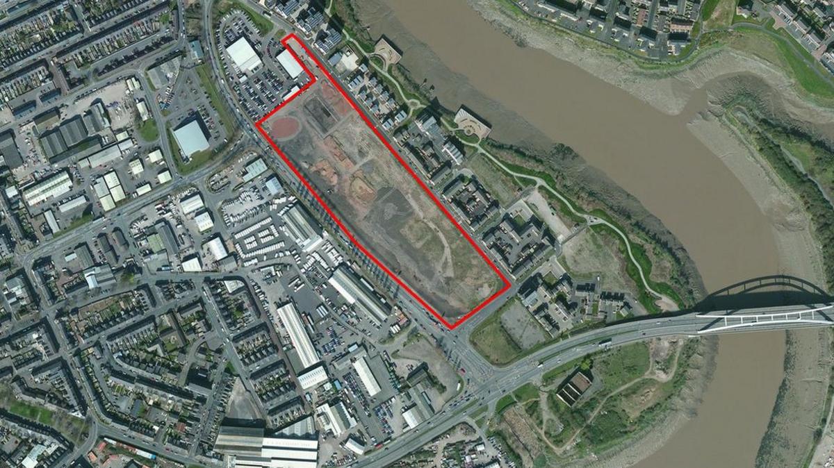 An aerial view shows the site outlined in red