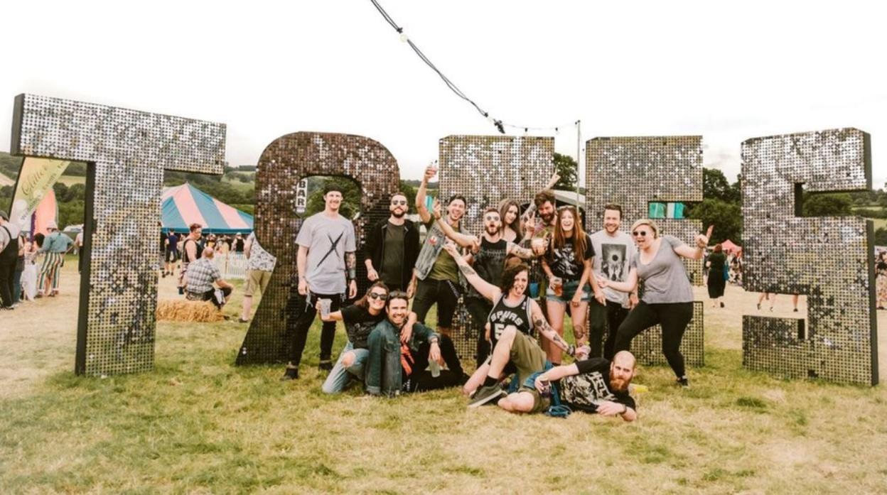 A group of people in front of a festival sign