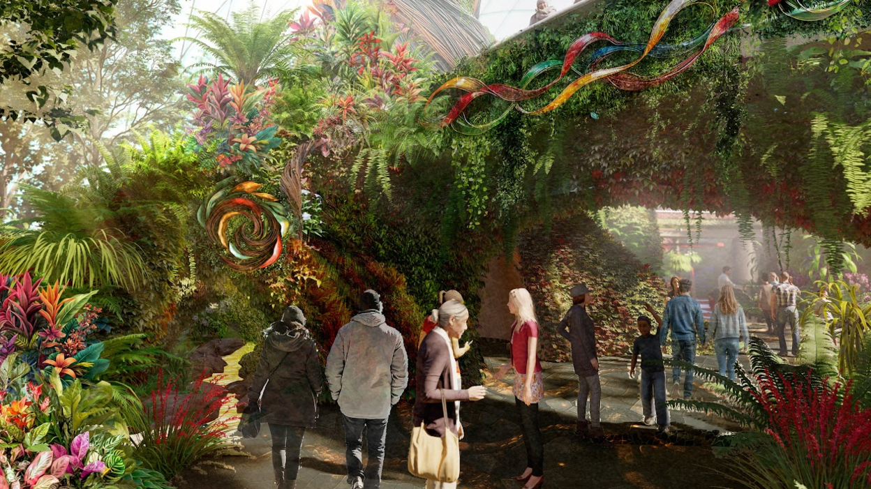 The images shows visitors walking amid lush tropical greenery