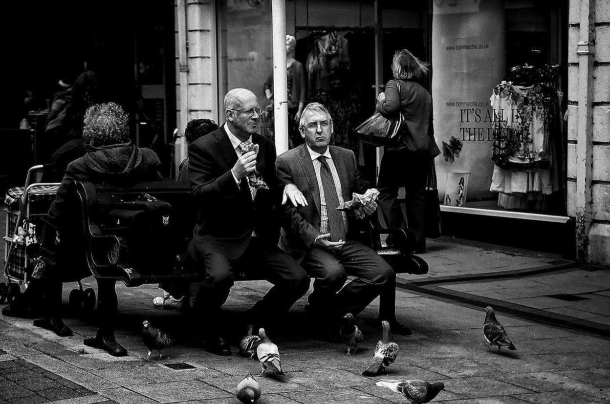 Photo of men on a bench