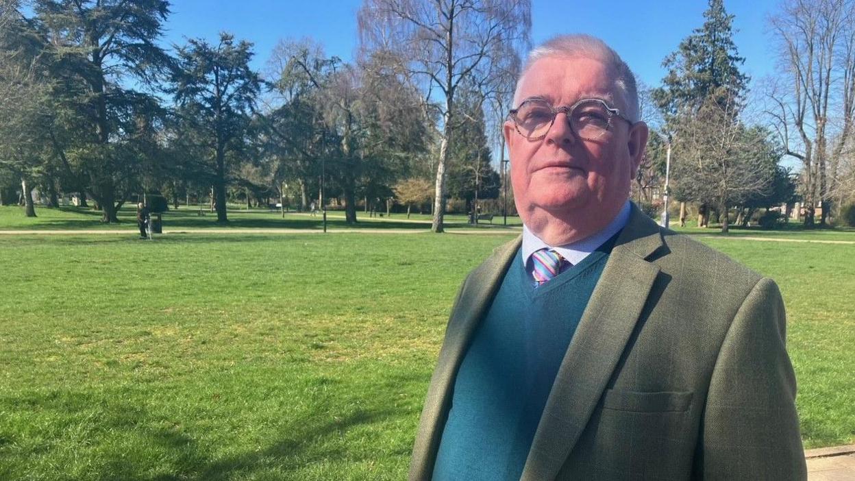 Labour Candidate John Tizard in a green jacket with a green jumper