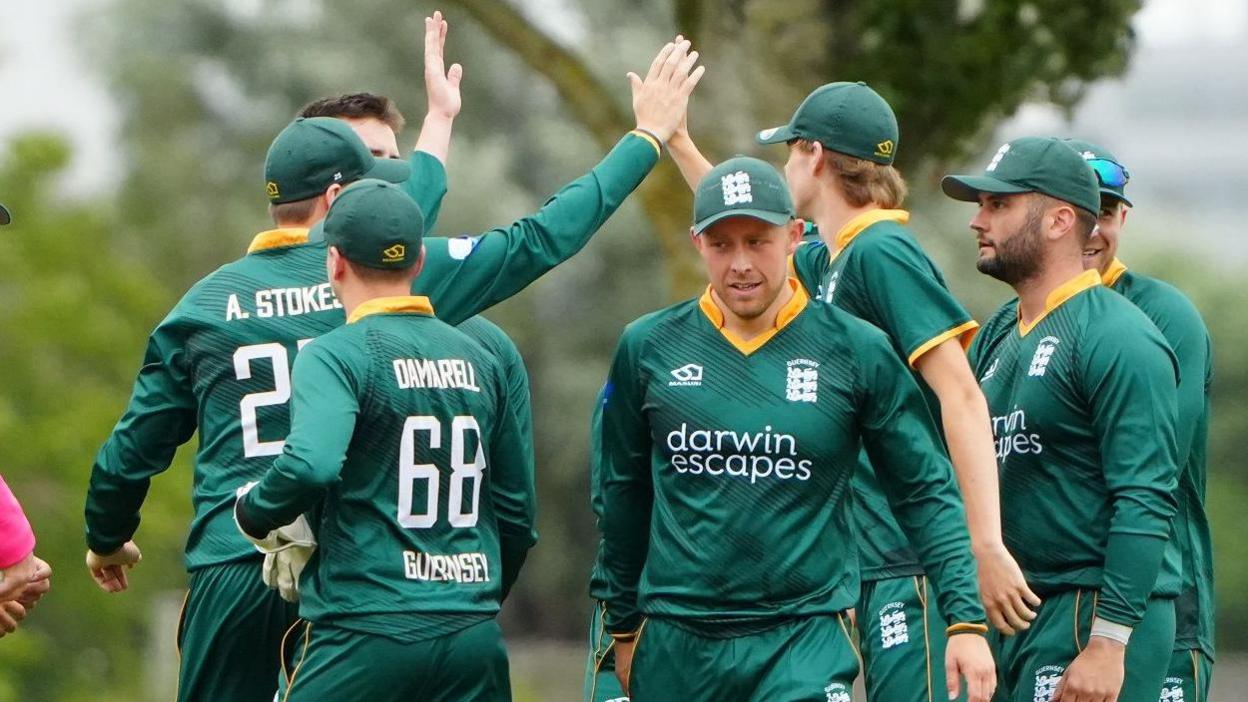 Guernsey cricketers celebrate a wicket
