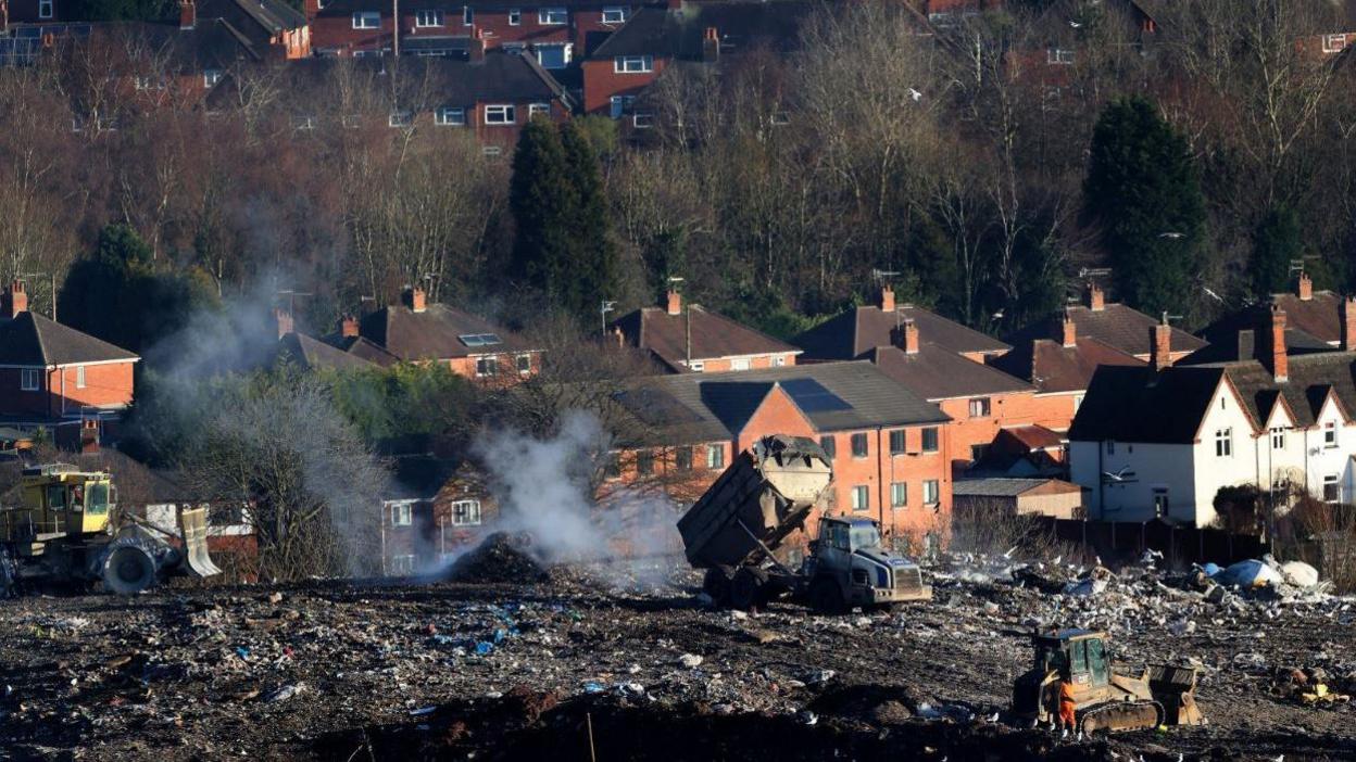 A view shows Walleys Quarry landfill next to residential properties in Silverdale As escaping hydrogen sulphide fumes from the landfill pollute the air.