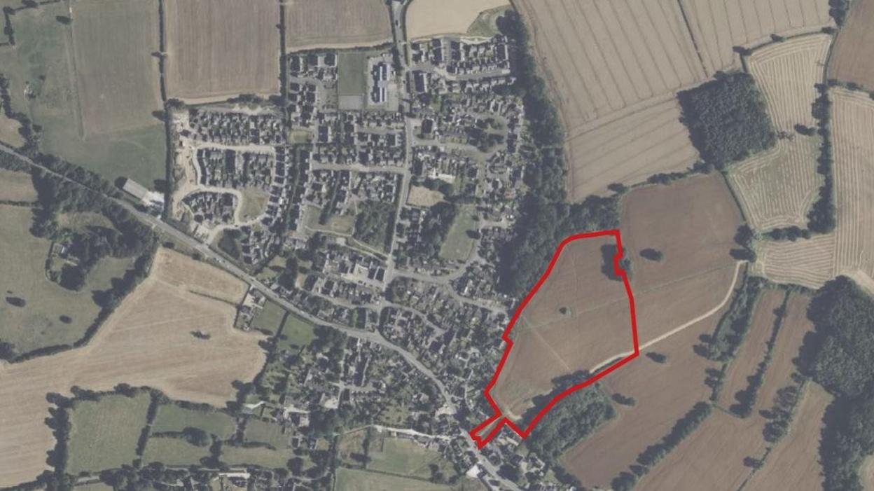 An aerial map of Brailsford - a village in Derbyshire. A section to the south-east of the image shows a field outlined in red where the houses would be built.