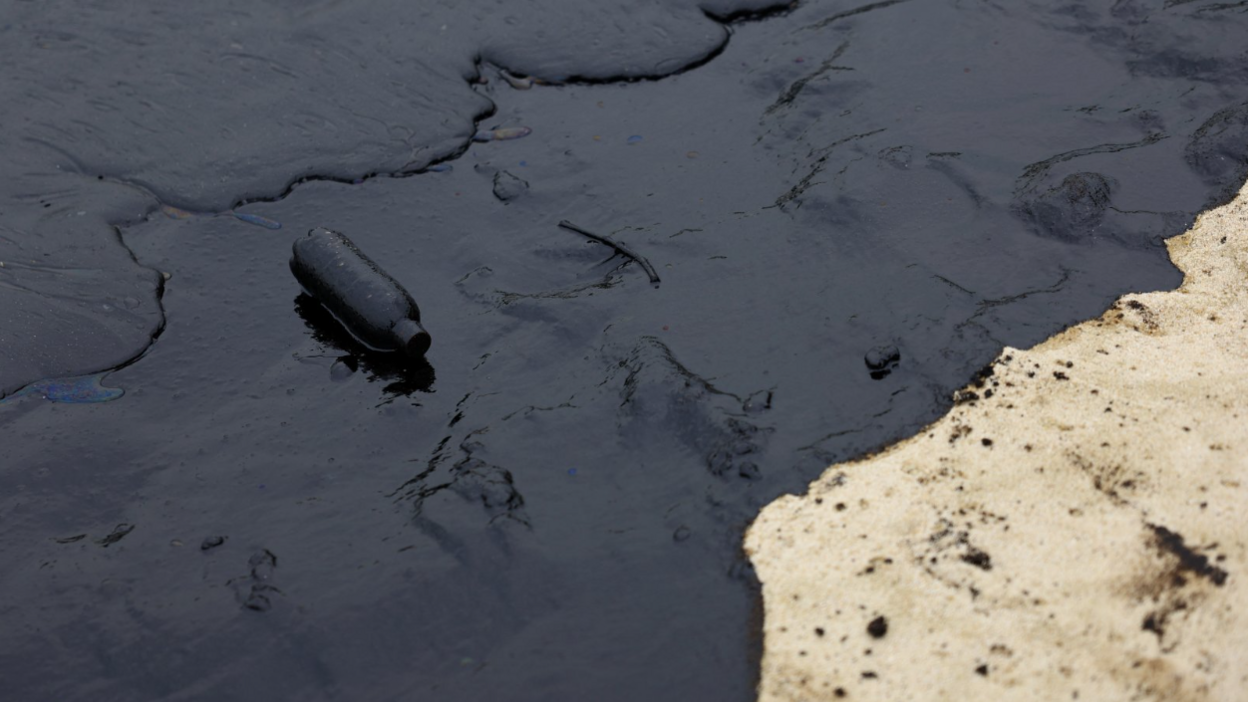 A plastic bottle coated in the slick