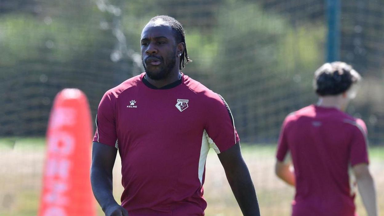 Michail Antonio, in a maroon Watford training top, pursing his lips