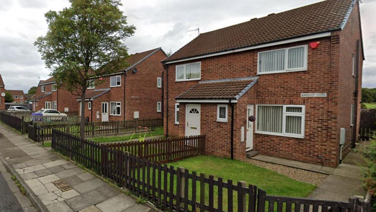 Kingsley Close. A street sign is attached to one of the homes at the end of the cul-de-sac.