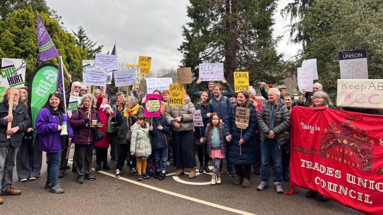 Dozens of people with banners which state their opposition to sell off or close care homes in Derbyshire