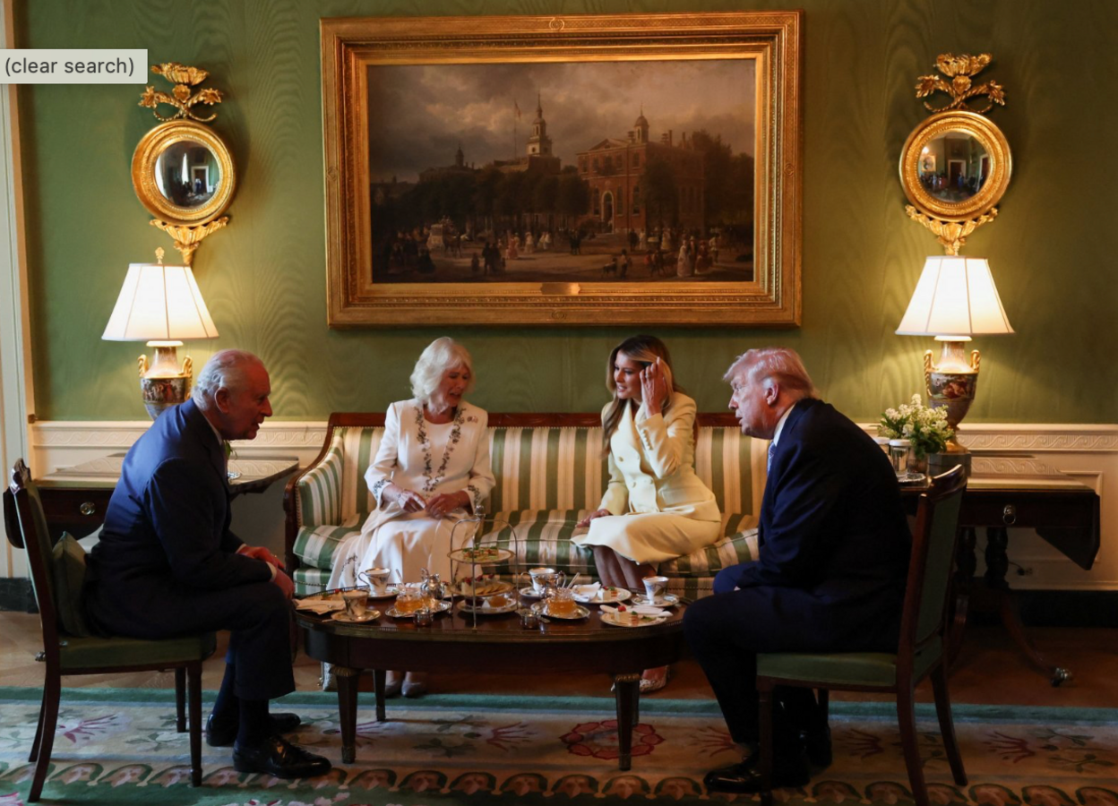 King Charles, Queen Camilla, First Lady Melania and US President Donald Trump are seen sitting around a small table cover in tea cups and dishes 
