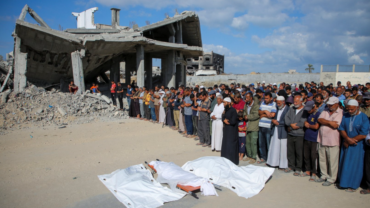 Mourners pray next to the bodies of Palestinians killed in Israeli strikes, during their funeral, amid the Israel-Hamas conflict, in Khan Younis in the southern Gaza Strip, October 2, 2024.