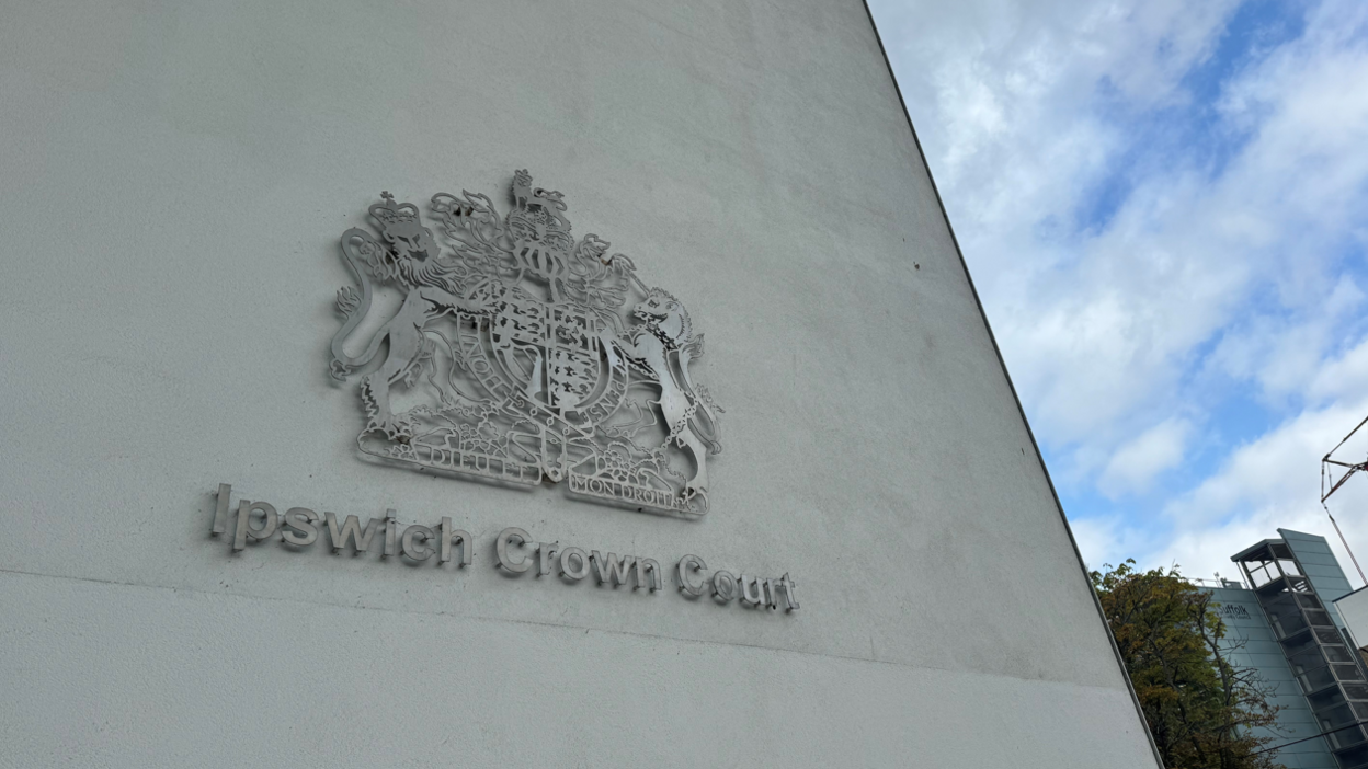 The Ipswich Crown Court logo on a concrete wall