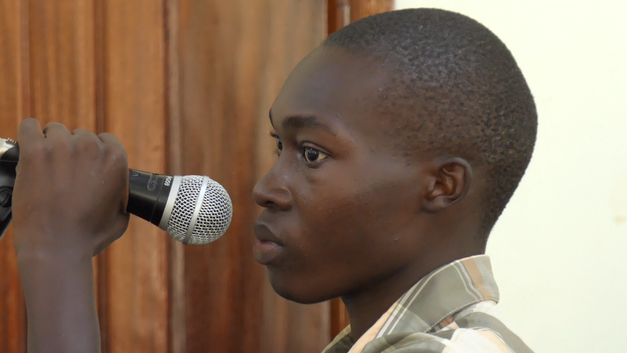 Emmanuel Nabugodi, Ugandan TikToker who has been jailed, holds a microphone in court. 