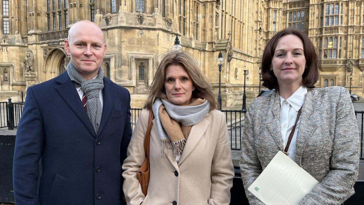 General view, Ellen Roome, Max Wilkinson, Lola Mcevoy outside parliament for Jools law debate. They are wearing winter coats and looking at the camera with the Houses of Parliament in the background