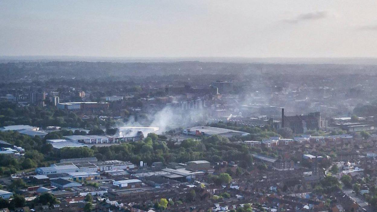 A drone image of the area affected by the fire the following day. Some smoke can still be seen billowing from the site.