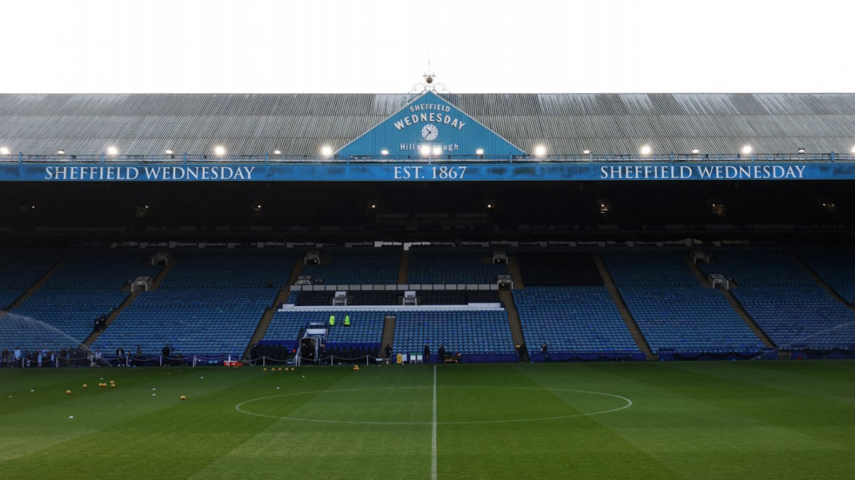 A wide shot of Hillsborough stadium, with sprinklers spraying on the grass.