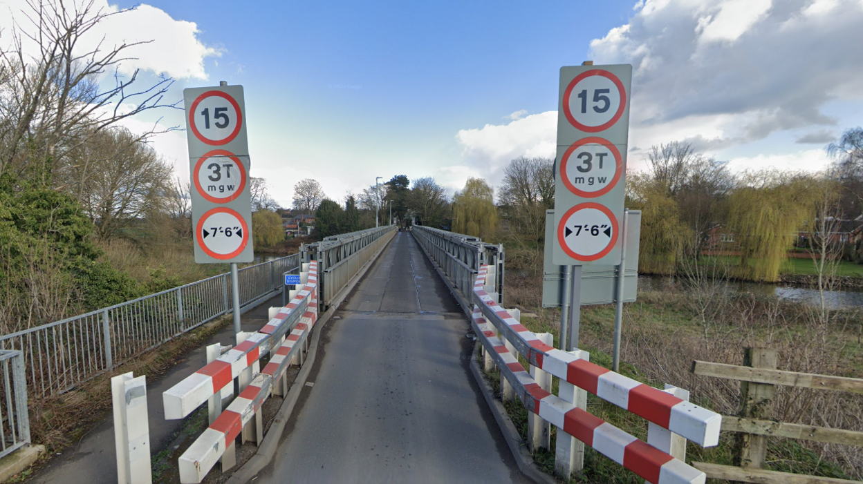 A Google Streetview image of Station Lane bridge showing it from end to end.