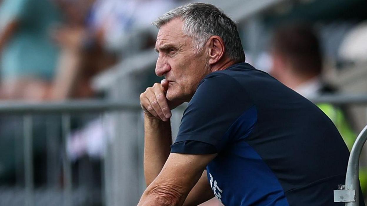 Tony Mowbray puts his finger to his mouth as he looks deep in thought