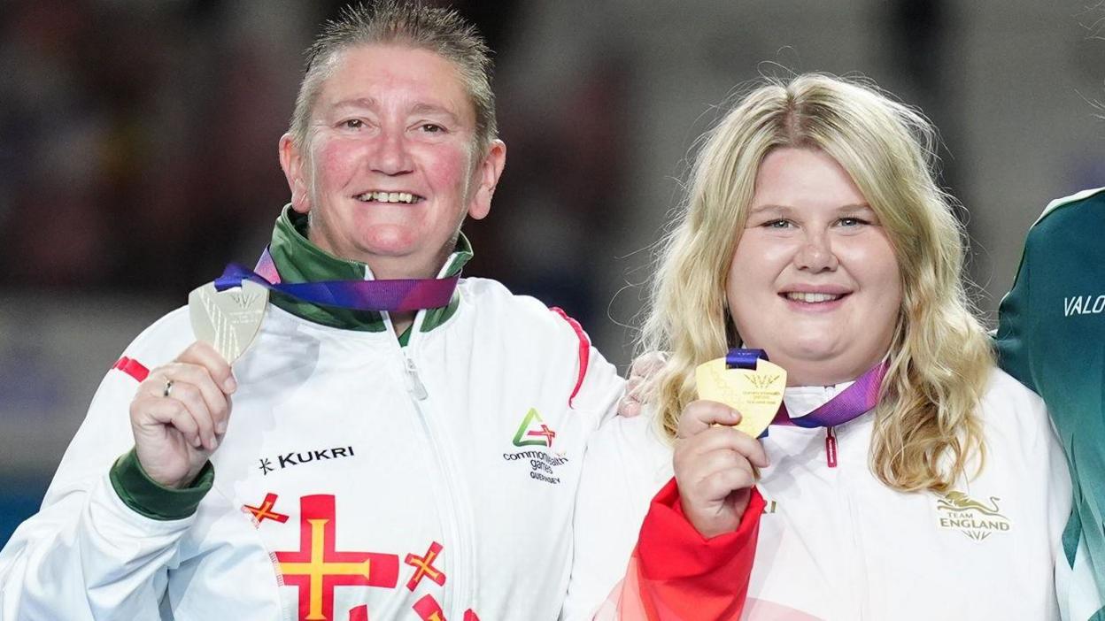 Katherine Rednall (right) holds her gold medal as Guernsey's Alison Merrien holds her silver medal