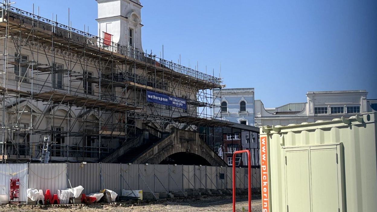 Leicester's Corn Exchange, covered in scaffolding, behind the Rialto bridge