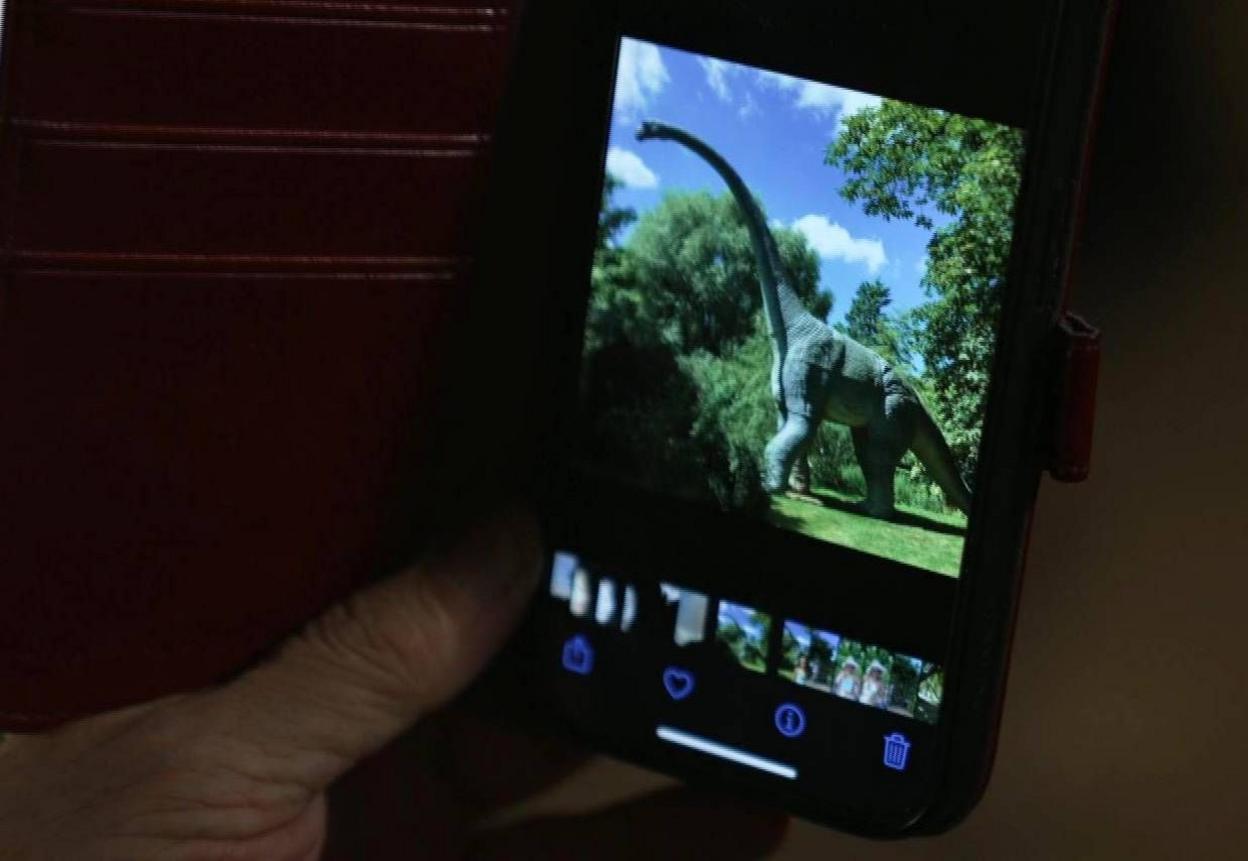 Tim Burton shows the BBC a picture of one of his dinosaur models 