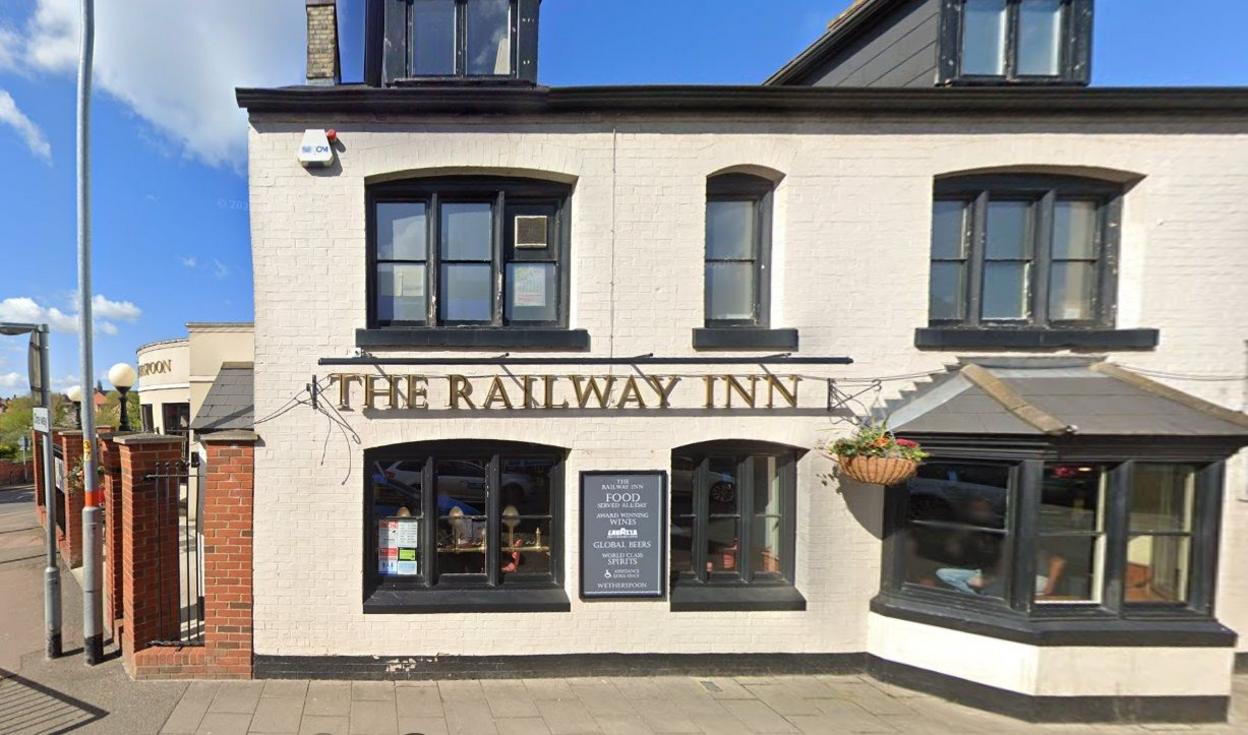 Two-storey, cream-faced pub building with bay window and a grey sign on the wall.