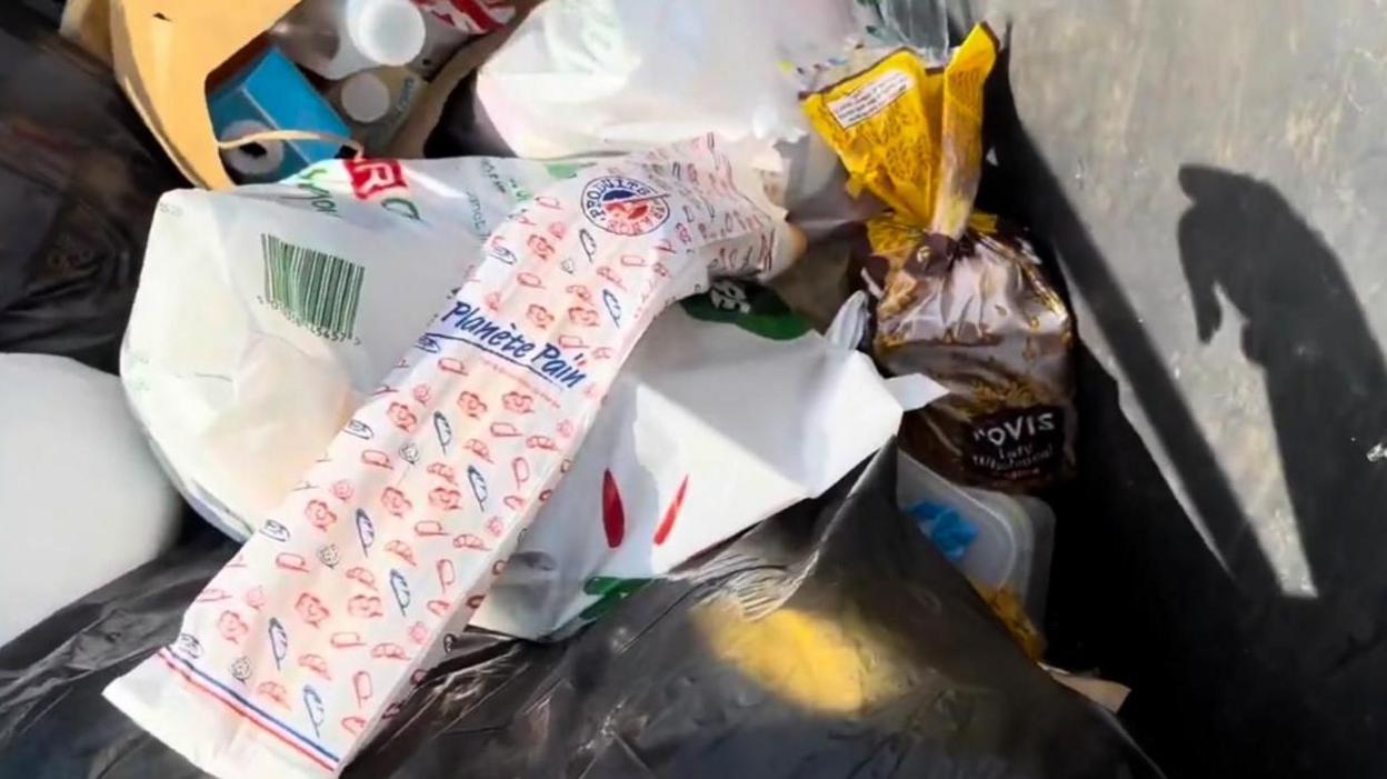 A pile of rubbish including food packaging