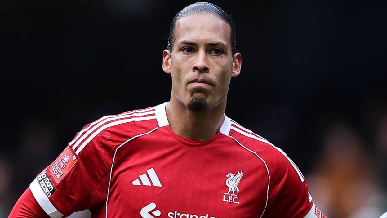 Liverpool captain Virgil van Dijk looks on as he stands with his hands resting on his hips after Liverpool's FA Cup defeat by Manchester City 
