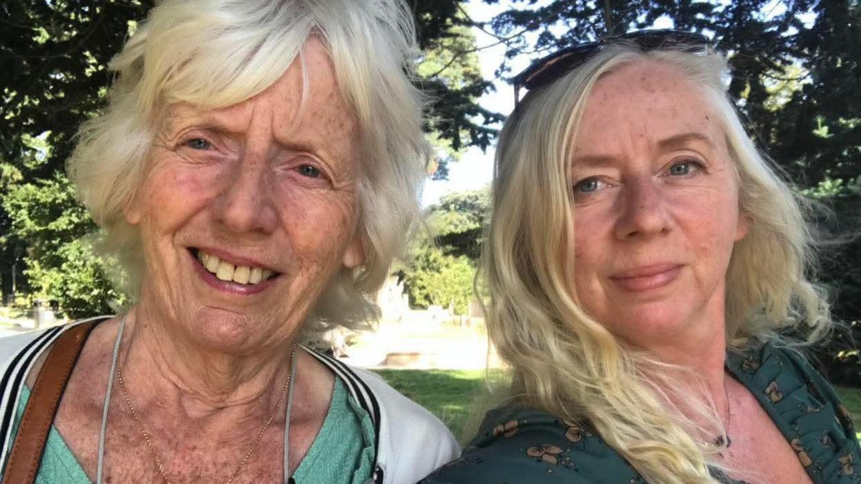 Dawn Booth and her mother Mavis Cooper. The pair are posing for a selfie. They both have fair hair. 