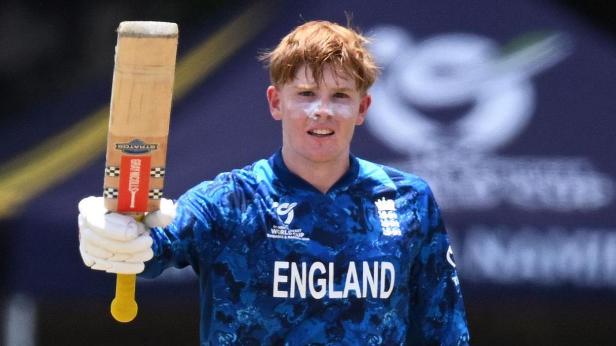 England Under-19 captain Thomas Rew raises his bat after hitting a century