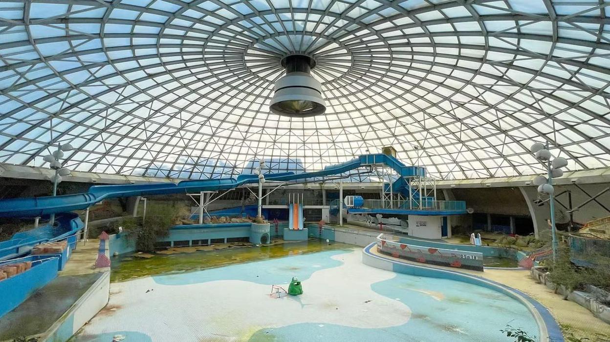 A recent photograph of the lagoon pool area shows murky green water, mould and crumbling surroundings under its famous domed roof.