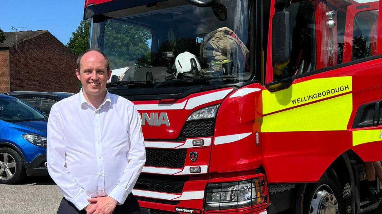 David Goss in front of a fire engine