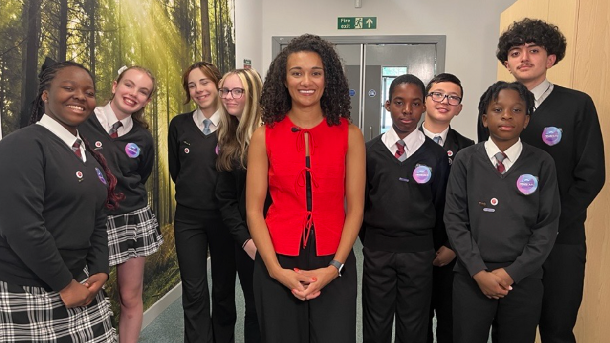 Nina with children at a school who have been reacting to the news.