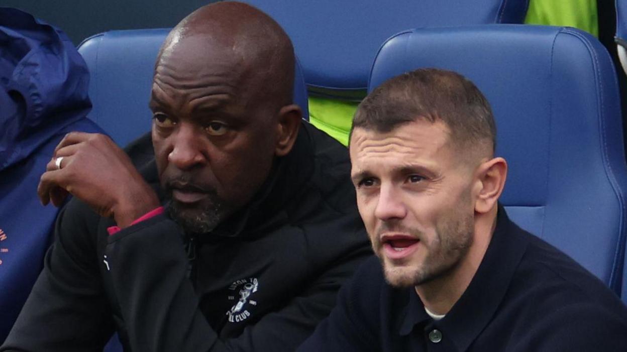 Luton Town assistant Chris Powell and boss Jack Wilshere look on