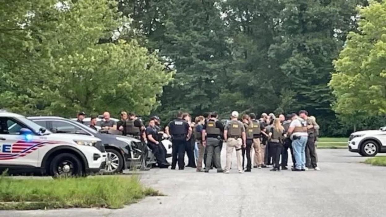 About 20 federal agents - including some with FBI marked on their backs - gathered in a car park.