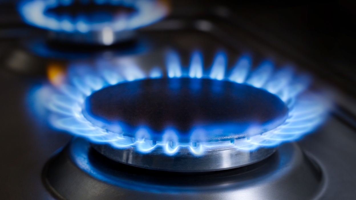 A blue flame burning on a gas hob