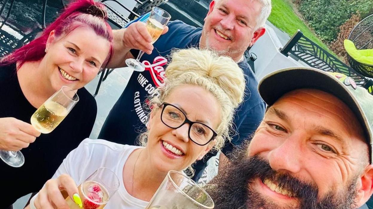 (l-r) New Inn owners Kirsty Watts, Adam Watts, Jema Paull and Nate Saitch - all four are holding prosecco with a garden scene behind them