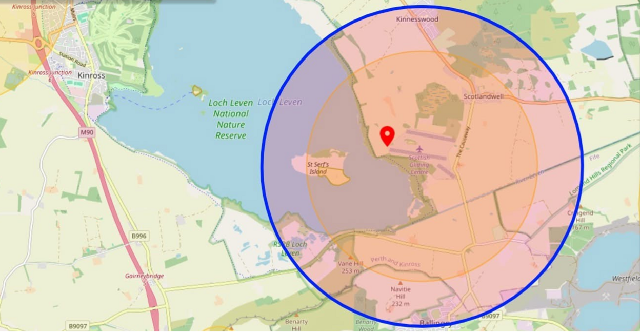 A map showing a circle indicating airspace restrictions covering an area of land and part of a body of water