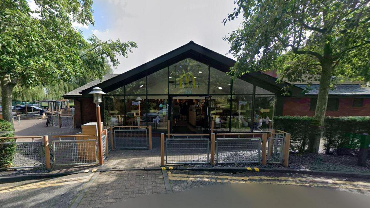 The outside of the Bracknell McDonalds trees can be seen either side of the entrance