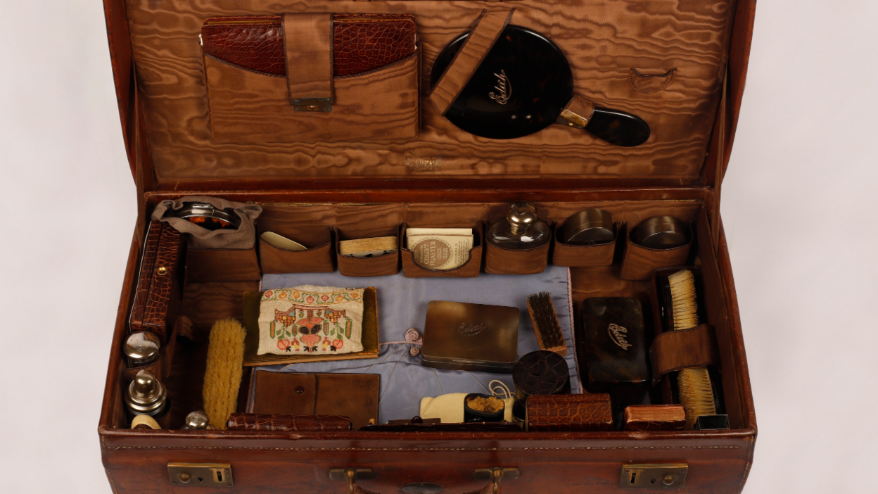 Another view of the inside of the travel case with several items inside of it.