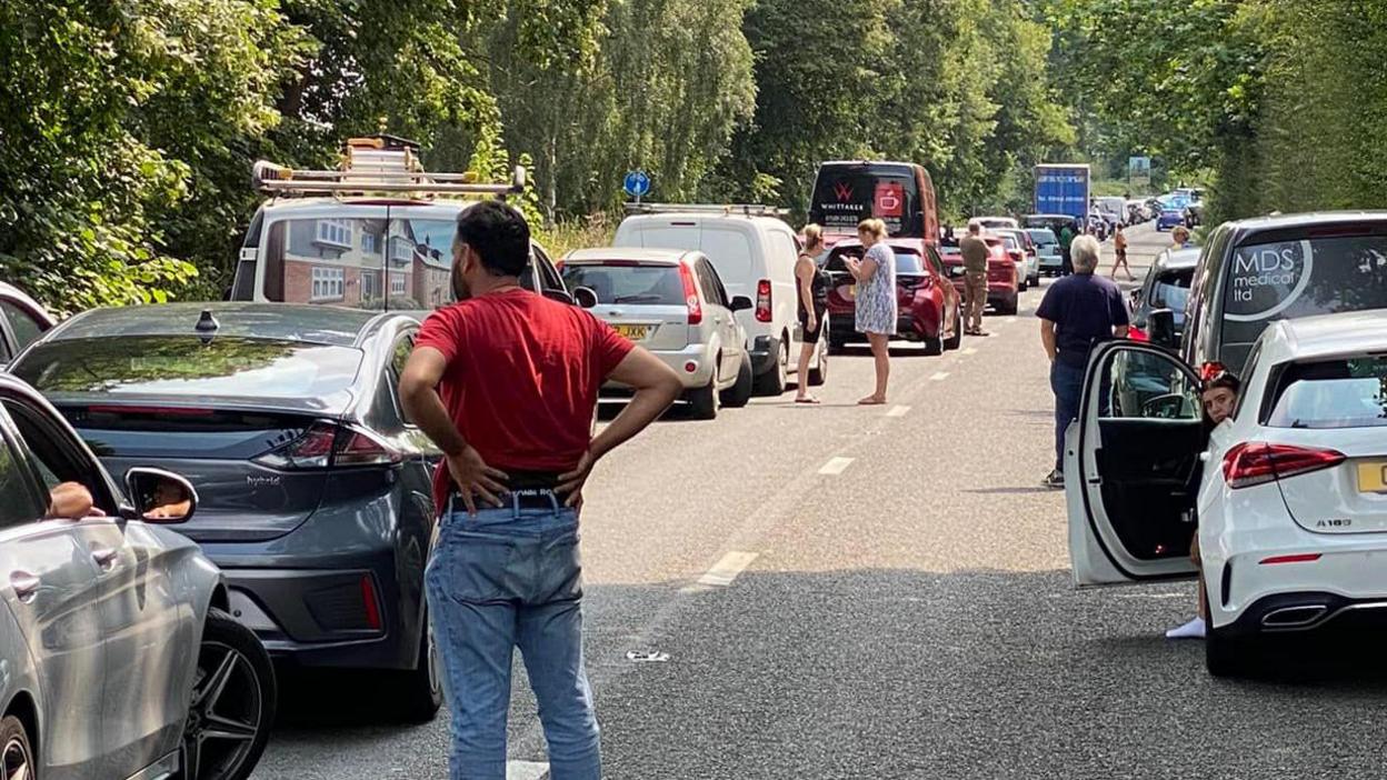 Cars at a standstill with drivers out of their vehicles