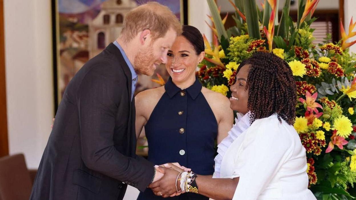 Britain's Prince Harry and Colombia's Vice President Francia Marquez shake hands, as Meghan, Duchess of Sussex, looks on, in Bogota, Colombia.