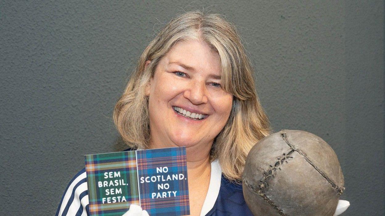 Caroline Mathers, Director of the Stirling Smith Art Gallery & Museum, with the world's oldest football before its departure for Miami for the World Cup match between Brazil and Scotland on 24 June.