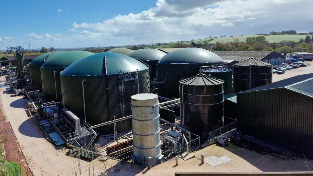 An anaerobic digester plant with large tanks and connecting pipes